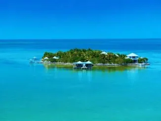 Aerial view of Cayo Espanto Belize private island resort surrounded by turquoise Caribbean waters