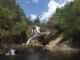 Big Rock Falls cascading into a clear turquoise pool in Mountain Pine Ridge Forest Reserve, Belize