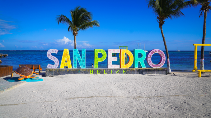 things to do in san pedro belize Colorful shops and golf carts along a sandy street in downtown San Pedro, Belize