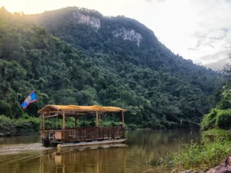 Canoe on the Macal River surrounded by tropical jungle during river expeditions in Belize