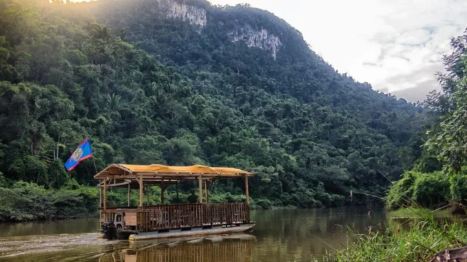 Canoe on the Macal River surrounded by tropical jungle during river expeditions in Belize
