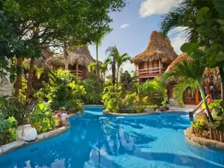 Aerial view of an all-inclusive beach resort in Ambergris Caye, Belize with turquoise waters and overwater