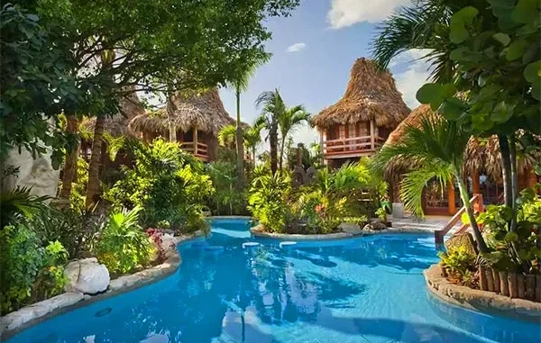 Aerial view of an all-inclusive beach resort in Ambergris Caye, Belize with turquoise waters and overwater