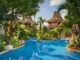 Aerial view of an all-inclusive beach resort in Ambergris Caye, Belize with turquoise waters and overwater