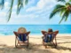 Retired couple enjoying a peaceful sunset walk on the beach in Belize