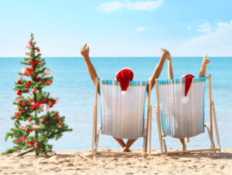 Christmas in Belize celebrated on a tropical beach with palm trees, sunshine, and festive decorations.